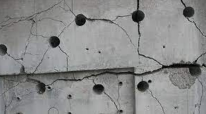 Grey wall with drill holes